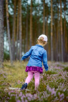 Adorable girl having fun on beautiful autumn day. authentic childhood image