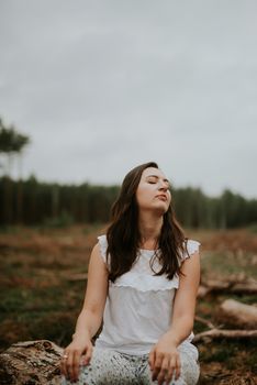 a photo of woman in the forest where the purple heather blooms. copy space. authentic image