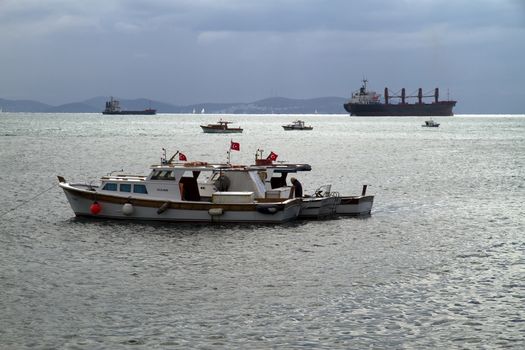Local Fishing Boats Swaying on the Waves in Bosphorus on Against Cloudy Sky