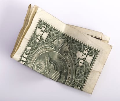 one crumpled one dollar banknote, isolated on white background.