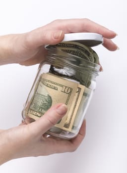 hands closing glass jar with money