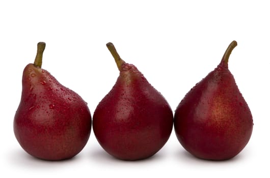  three red pears isolated on white background with water drops