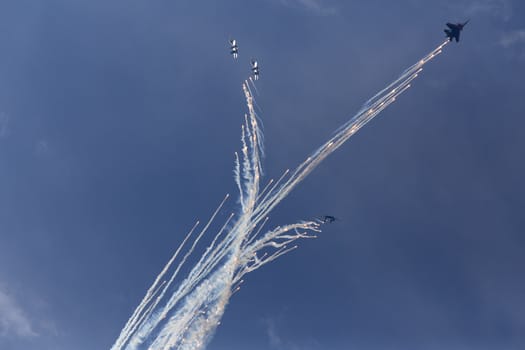 Military aircrafts making a stunt with fireworks. Russia, Moscow Airshow in July 2017
