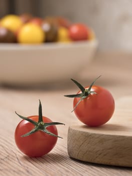 Cherry tomatoes, red,yellow and kamato on a wooden table.