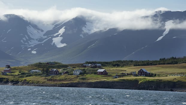 Typical icelandic landscape with houses. Seashore of the Atlantic Ocean