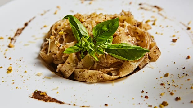 Tagliatelle with mushrooms and decorated with basil leaves