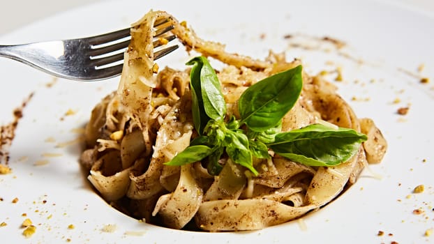 Tagliatelle with mushrooms and decorated with basil leaves