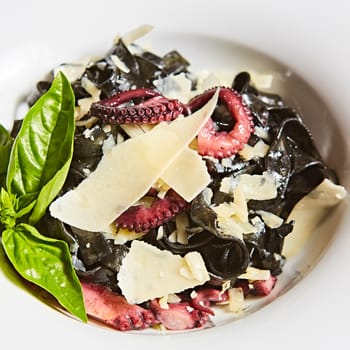 Pasta with black cuttlefish ink, octopuses and parmesan