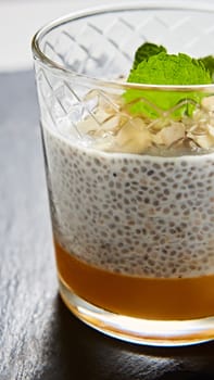 Mango yogurt with chia seeds for healthy brekfast on a white background, copy space