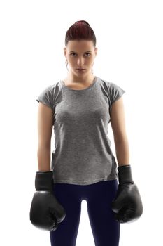 A portrait of a beautiful young girl with boxing gloves under harsh lightning, isolated on white background.