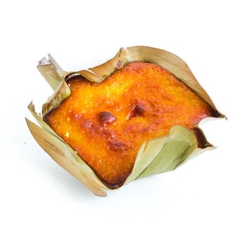 Single mini Bibingka, traditional Philippines cake isolated on white background. A Filipino baked rice with butter and cheese in banana leaves, usually eaten for breakfast, especially during Christmas season