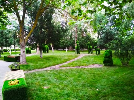 
Figures of animals made of artificial material green in the Park in the summer.