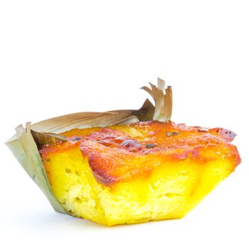 Half cut Bibingka, traditional Philippines cake isolated on white background. A Filipino baked rice with butter and cheese in banana leaves, usually eaten for breakfast, especially during Christmas season