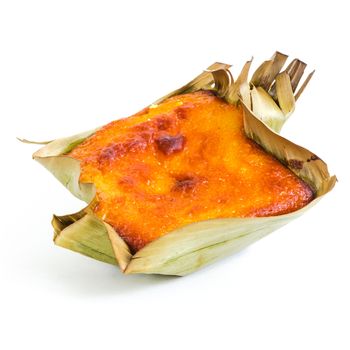 Single mini Bibingka, traditional Philippines cake isolated on white background. A Filipino baked rice with butter and cheese in banana leaves, usually eaten for breakfast, especially during Christmas season
