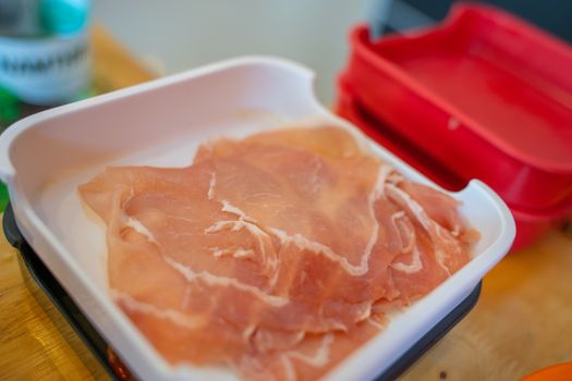 The sliced raw pork meat isolated on white background. Top view.