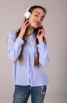 Beautiful young woman listen music with headphones