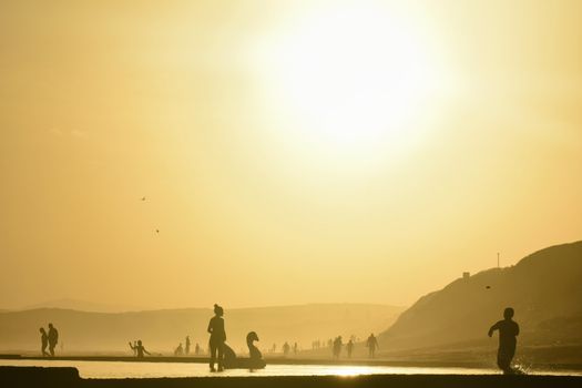 Summer vacation activity in a local tide pool during the afternoon, Mossel Bay, South Africa