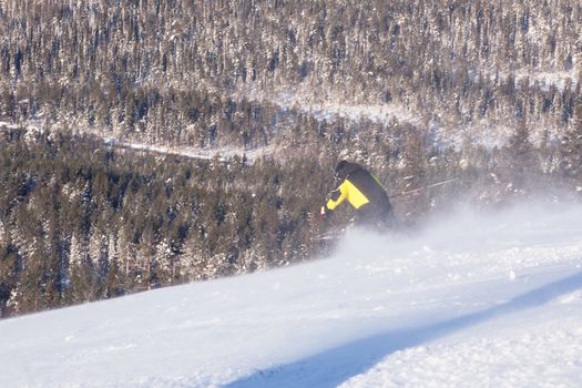 Skier in mountains, prepared piste and sunny day