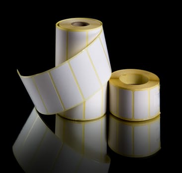 Print labels in rolls isolated on black background