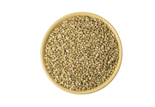 Natural fresh green buckwheat in ceramic bowl on white background. Top view.