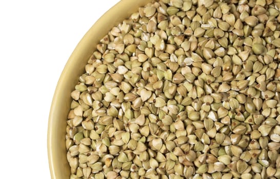 Natural fresh green buckwheat in ceramic bowl on white background. Top view.