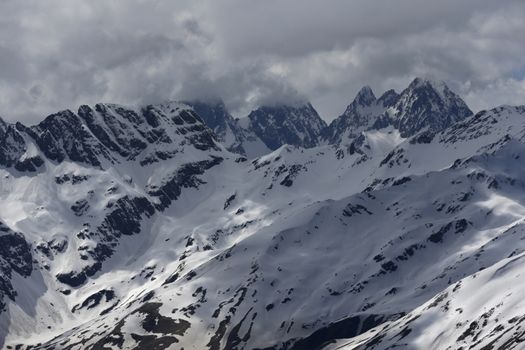 View of Snow Mountain Range Landscape with Blue Sky. Russia, Caucasus.