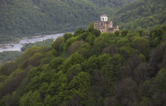mountains covered by forest and old church 10 century 