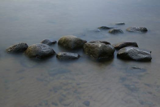 Stones in the Water at Evening Sun, Long time Exposure