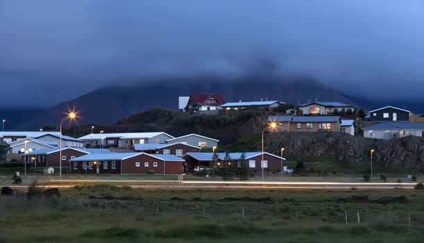 Small icelandic village in the foot of volcano at night 