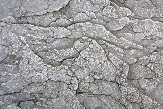 stone surface with cracks and scratches, grey colour.