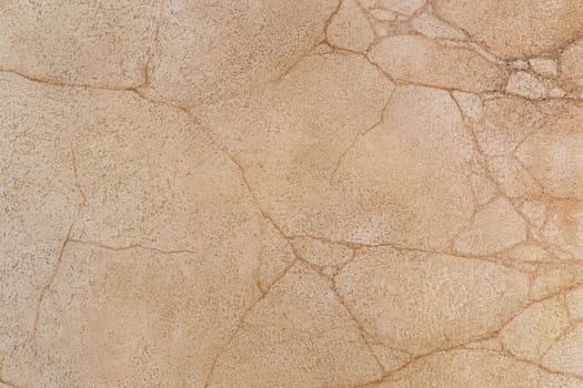 fragment of the stone orange wall with cracks