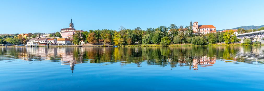 Panoramic cityscape of Litomerice reflected in Labe River, Czech Republic.