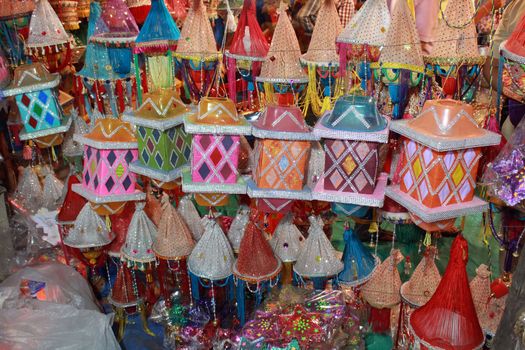 Beautiful traditional Diwali lanterns made of beads and colorful threads in a workshop.