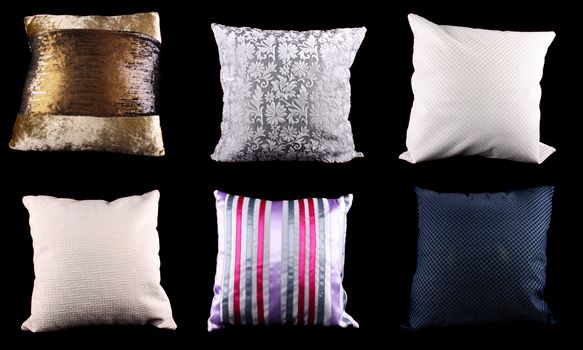 A set of square cushions made from different designs and material, on black studio background.