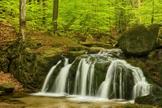 Beautiful Maly waterfall in super green spring forest surroundings, Czech Republic