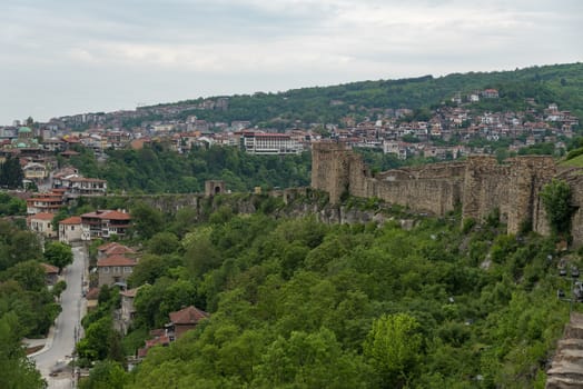 Veliko Tarnovo, Bulgaria - 8 may, 2019:  Gate tower and ruins of Tsarevets fortress with a view of the old town of Veliko Tarnovo in the background, Bulgaria