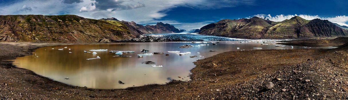 Panorama of Skaftafellsjökull glacier in Iceland with surrounding mountains and lagoon