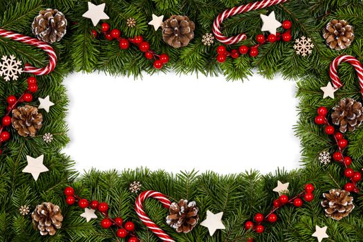Christmas Border frame of tree branches on white background with copy space isolated, red and white decor, berries, stars, cones