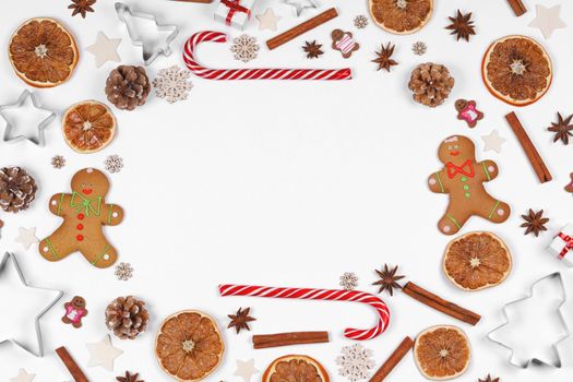 Christmas food frame. Gingerbread cookies, spices and decorations on white background with copy space