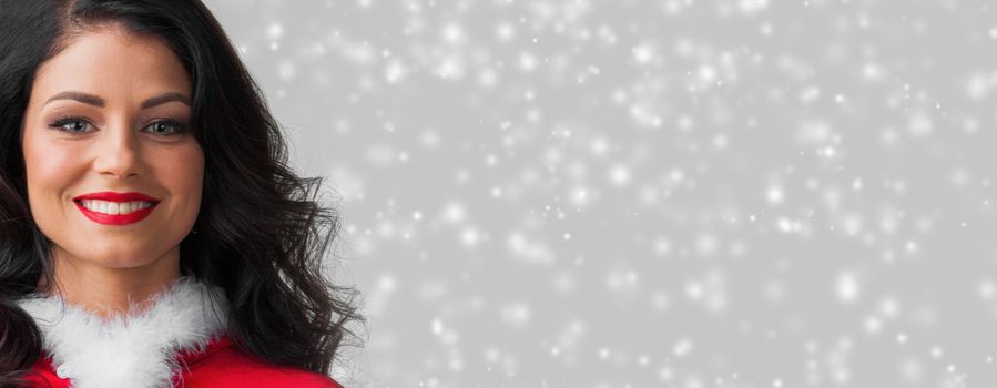 Beautiful happy woman in Santa Claus clothes on glowing lights bokeh background