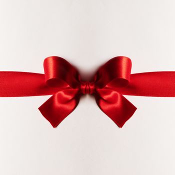 Red gift satin bow on white background