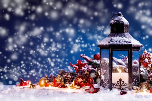 Burning candles , lantern and christmas decoration on magic bokeh lights background