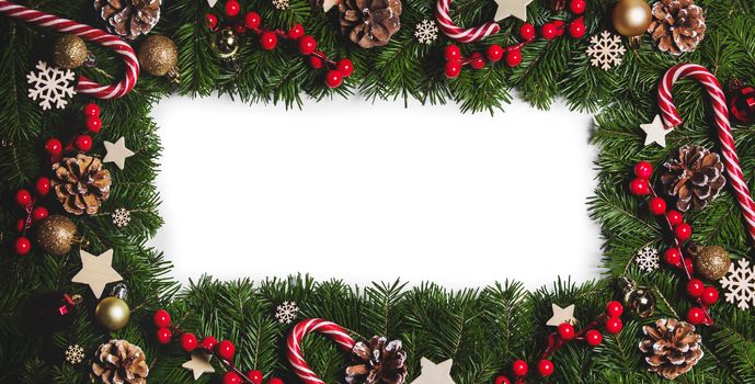 Christmas Border frame of tree branches on white background with copy space isolated, red and white decor, berries, stars, cones