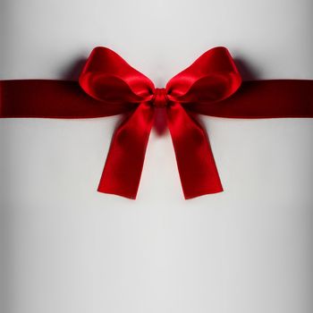 Red gift satin bow on light background