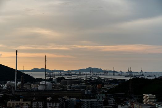 The small town silhouette with the port background at sunset