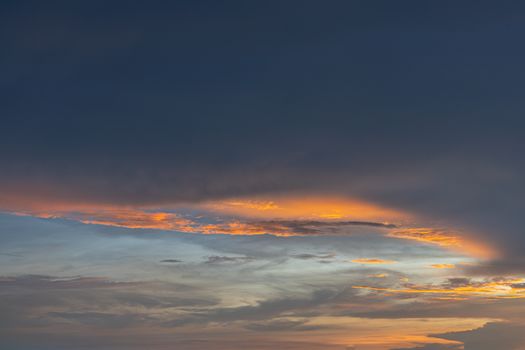 The Bright orange and gold colors of the sunset sky. Summer sky with clouds during the sunset