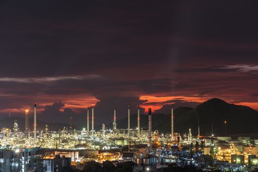 The Oil refinery is located in one of the city during the sunset behind the hills to the sea, a beautiful pictures can be made into a background image