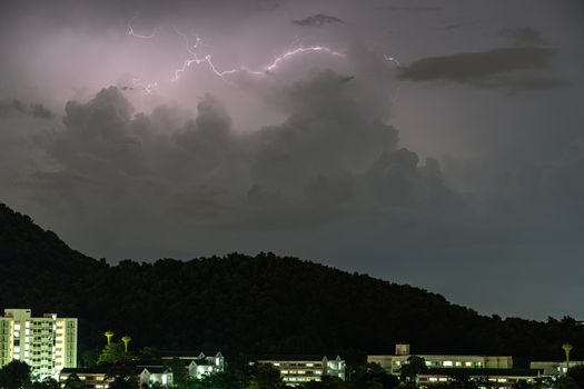 The Storm lightning strikes in mountains during a thunderstorm at night. Beautiful dramatic view