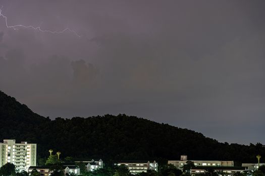 The Storm lightning strikes in mountains during a thunderstorm at night. Beautiful dramatic view