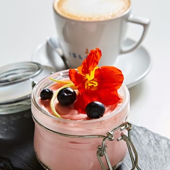 Fresh strawberry yoghurt dessert in glass, selective focus.